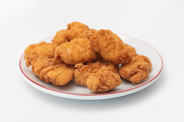 Fried chicken wings on a plate on a white background, close-up