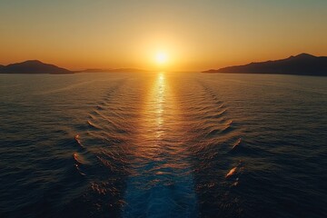Sunset over calm waters with rippling wake and distant mountains under a clear sky