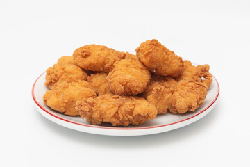 Fried chicken wings on a plate on a white background, close-up