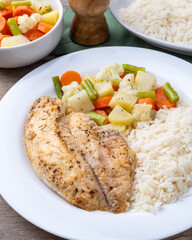 Grilled tilapia or saint peter with rice and vegetables