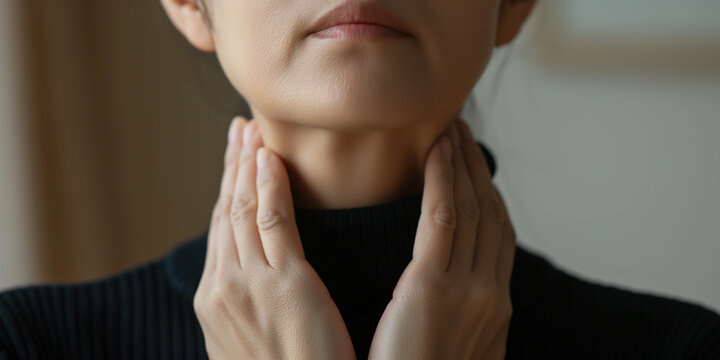 Woman suffering from sore throat holding her hands around neck
