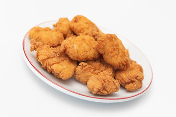 Fried chicken wings on a plate on a white background, close-up