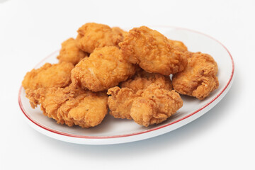 Fried chicken wings on a plate on a white background, close-up