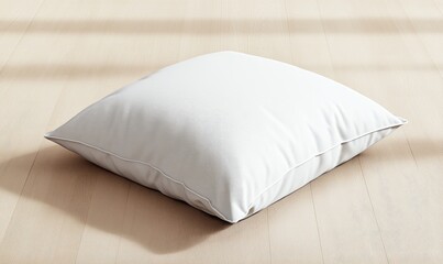 A white pillow sits on a wooden floor