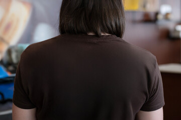 Woman's back with brown t-shirt