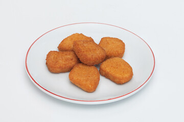 GeneraFried chicken wings on a plate on a white background  close-upted image