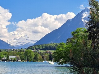 A lake in the Swiss Alps. The Blue Lake in Switzerland. Snow-capped mountains near the lake. Spring.