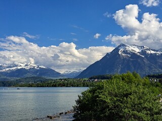 A lake in the Swiss Alps. The Blue Lake in Switzerland. Snow-capped mountains near the lake. Spring.