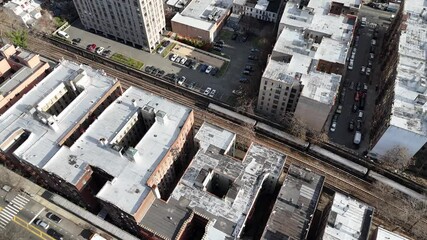 Vertical drone tracking shot over Ocean Ave in Brooklyn, capturing New York’s vibrant urban streets, charming rooftops, and dynamic skyline with smooth forward motion.