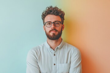 Obraz premium Stylish Young Man with Glasses Posing Against a Colorful Background
