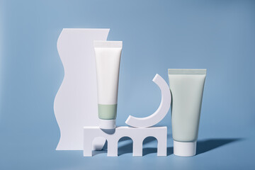 Cosmetic tubes on abstract geometric podiums in pastel colors