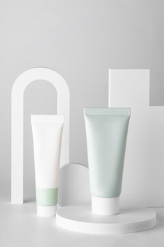 Cosmetic tubes on geometric podiums in minimalist style