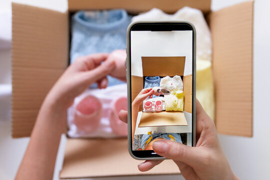Young Woman Taking Photos of Clothes for Online Closet Sale