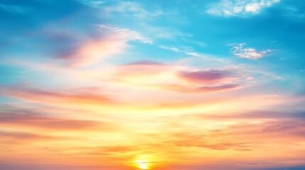 Obraz premium Stunning sunset over the horizon with vibrant color and soft clouds, creating a serene atmosphere