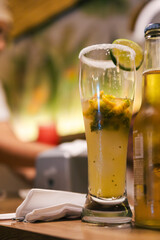 Michelada beer cocktail with lime and salt on bar counter in colombia