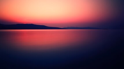 Obraz premium Serene Pink Sunset over Calm Ocean Water Landscape