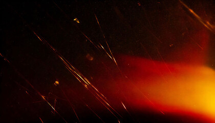 Abstract scratched damaged retro analog film effect, red yellow orange light leaks rays, grainy dust noise texture on black background, blurred vintage cinematic distressed grunge overlay.