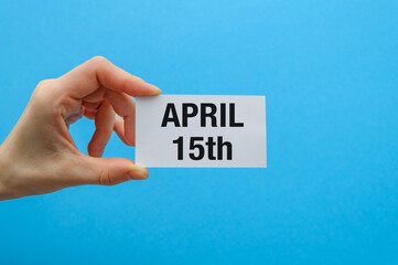 Us individual income tax return 1040 form for 2025 with tax day text and April 15th on paper card in hand.