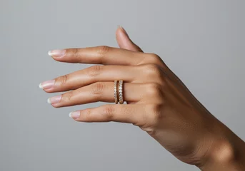 Hand wearing two gold rings. Fashion rings on a hand. Jewelry on hand