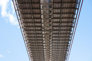 The bridge is very tall and has a lot of metal