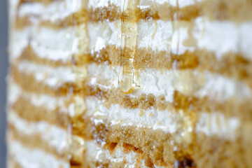 Honey dripping onto layers of cake creating a delectable dessert