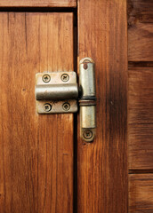 Fototapeta premium A wooden door with a hinge that is slightly open