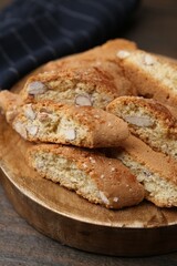 Tasty almond biscuits (Cantuccini) on wooden table, closeup
