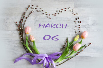 Calendar for March 6: numbers 06, name of the month March in English in a heart of flowers