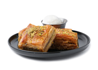 Delicious baklava with crushed nuts and ice cream isolated on white