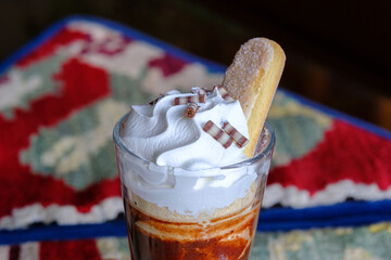 Coffee dessert with whipped cream and biscuit