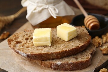 Slices of bread with butter and honey on table, closeup