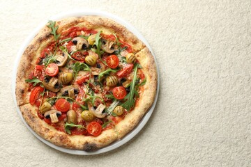 Tasty pizza with mushrooms, olives, tomatoes and arugula on white textured table, top view. Space for text