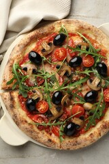 Tasty pizza with mushrooms, olives and arugula on light grey table, top view
