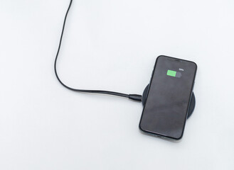Obraz premium the phone is charged by wireless charging