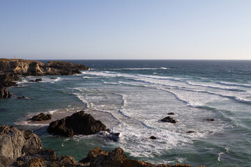 Stunning view of dramatic cliffs and the vast ocean in Porto Covo, Portugal, showcasing the power...