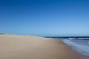 A beautiful beach with fine golden sand stretches along the Rota Vicentina trail, inviting visitors to explore its tranquil shores and enjoy the natural beauty of Portugal’s coast