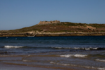 A beautiful view from a beach along the Rota Vicentina, looking out to a small island teeming with birds.