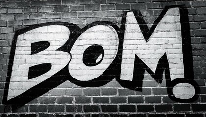 black and white close up of graffiti art on a brick wall spelling out the word boom the image evokes a sense of urban energy and street art culture