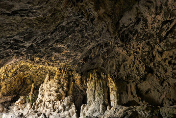 Cave interior with visible effects of karst processes like stalagmite and stalactite