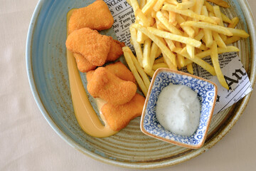 Crispy fried nuggets served with golden fries and a creamy dipping sauce