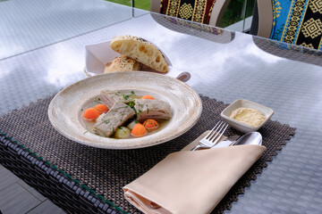 A hearty stew with meat and vegetables served with bread