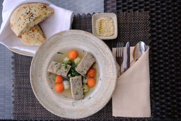 A hearty stew with meat vegetables and herbs served with bread