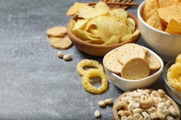Various unhealthy snacks on gray background
