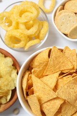 Various unhealthy snacks on white background
