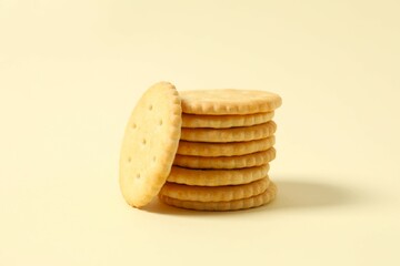 Delicious crispy crackers cookies on color background 