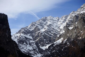 Majestic mountains with snow-covered slopes, illuminated by bright daylight. The clear blue sky...