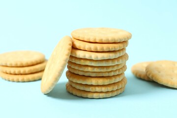 Delicious crispy crackers cookies on color background 