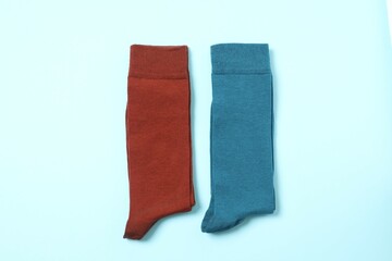Color socks on blue background, flat lay