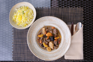 Savory stew with dried fruit and nuts served with saffron rice A delicious and aromatic meal