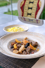 Savory stew with dried fruits and meat served with a side of rice